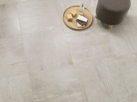 Un tabouret, un plateau et du savon posés sur le dallage effet béton Concrete Stone